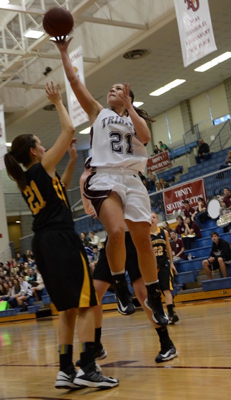 Junior forward Murphy Burns leaps over her defender for a layup in last week's victory against Southwestern. Photo by Aidan Kirksey.