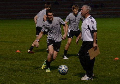 Junior Midfielder Alex Saadi dribbles the ball around head coach Paul McGinlay during spring training. Photo by Aidan Kirksey.