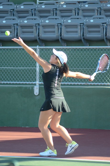 Junior Laura Roa readies to fire a serve at her opponent from Laredo Community College last Saturday. Trinity beat Laredo 9-0. Photo by Matthew Brink.