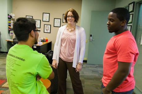 Junior Lawrence Pasaoa and sophomore chris Williams interact with Kate Polivka, the newly hired assistant director of Campus and Community Involvement, during 'milk and cookies' hour on Thursday. Photo by Anh-Viet Dinh.