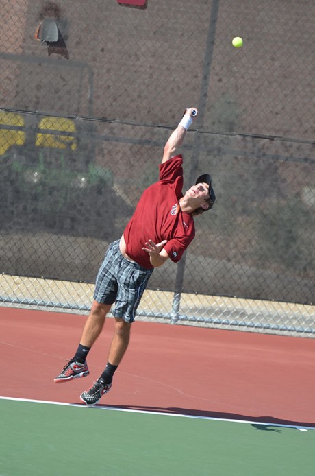 Sophomore Jordan Mayer serves a ball during his match against University of the Incarnate Word Cardinals on April 6. Photo by Anh-Viet Dinh.