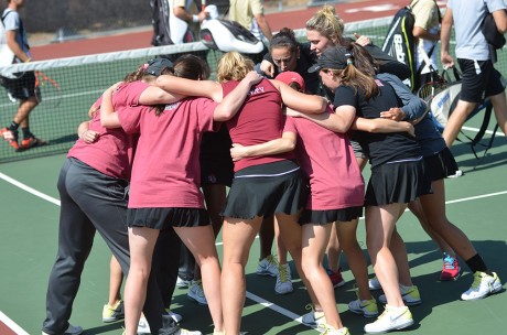 PLayers of the Trinity Tiger's Womens tennis team participate in a traditional group chant before the match against University of Incarnate Word and Texas Lutheran University last Saturday. Photo by Anh-Viet Dinh.
