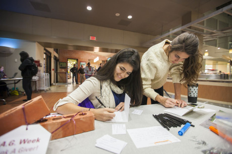 Jessica Avilez (Jr). Erika Migeon (SO). Writing thank you letters to those who donate to Trinity University during Student Ambassador's T.A.G. (Thank A Giver) Week event. Photo by Anh-Viet Dinh.